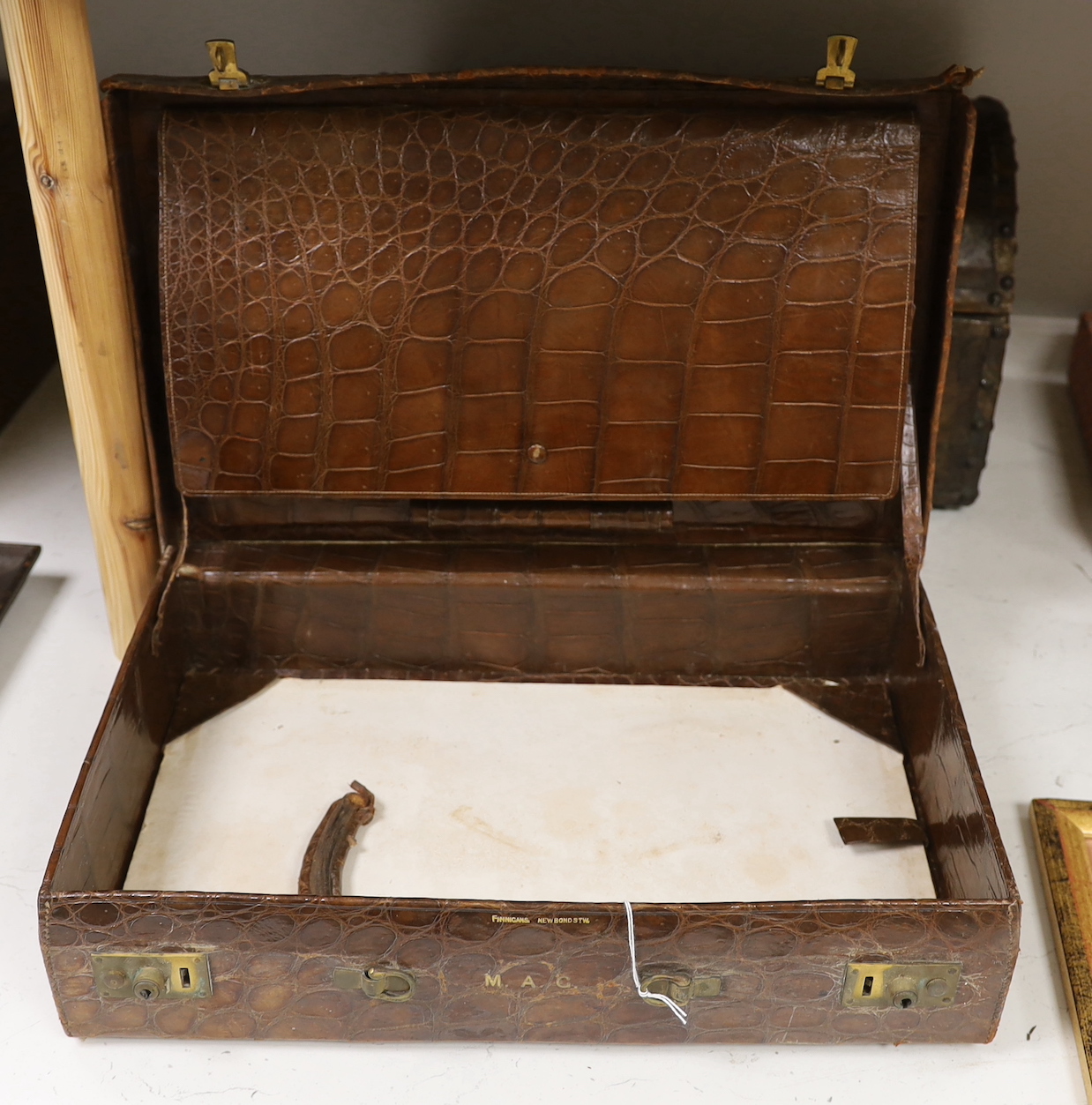 A Finnigans crocodile leather attaché case, pre 1940, with interior figments and blotter, 45cm wide, 28cm deep